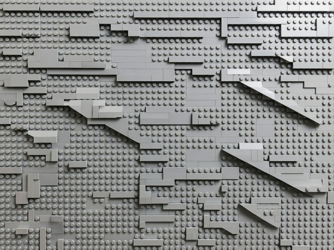 Interlocking brick wall showing overlapping seams, angled sections and smooth tiled surfaces